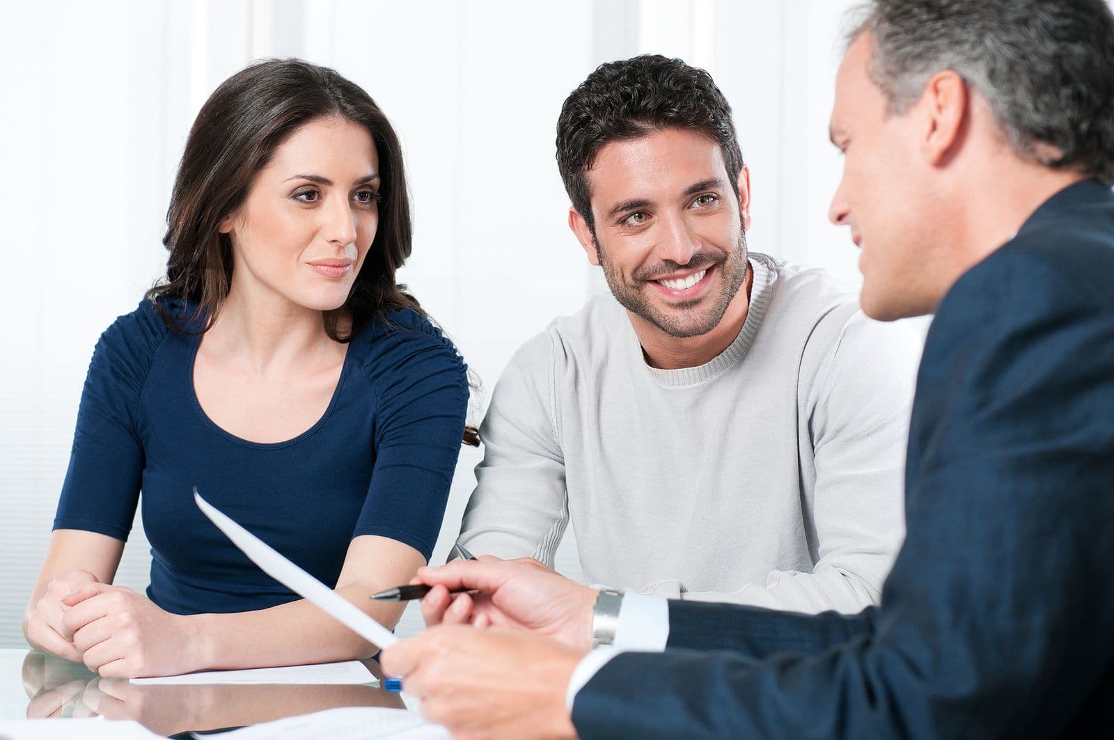 A professional presents options to a couple.