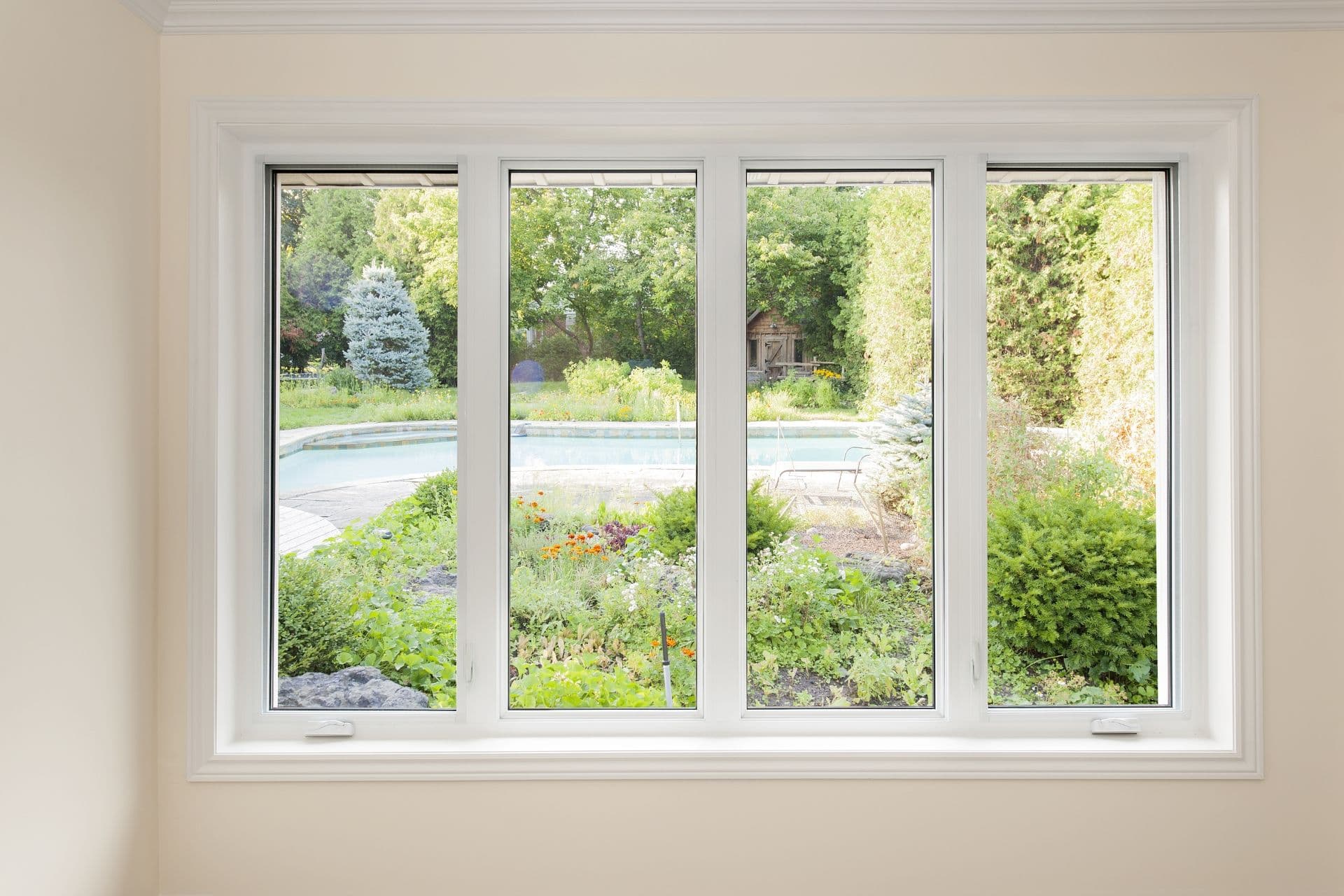 A large four-paned window looks out onto a yard.
