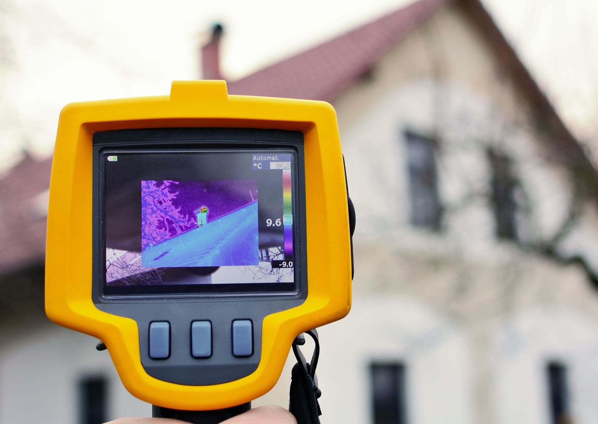 A thermal imaging camera looks at a roof on a house.