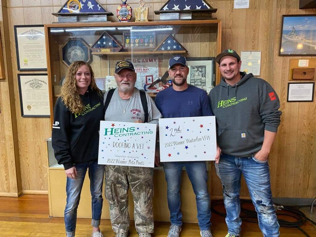 Heins Contracting employees with the winner of the 2022 Roofing a Vet giveaway.