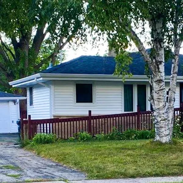 A white house with new gutters.