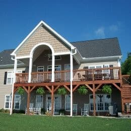 A house with tan James Hardie Everlast siding, white trim, and two-story deck.
