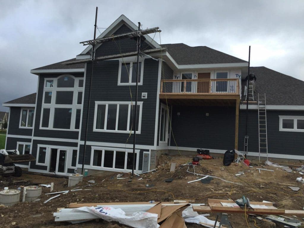 A dark gray house with white trim and LP Smart Siding.