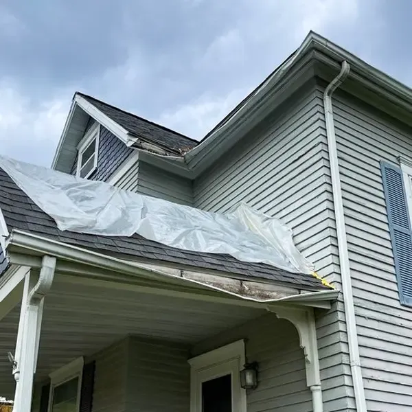 A storm-damaged roof and gutters.