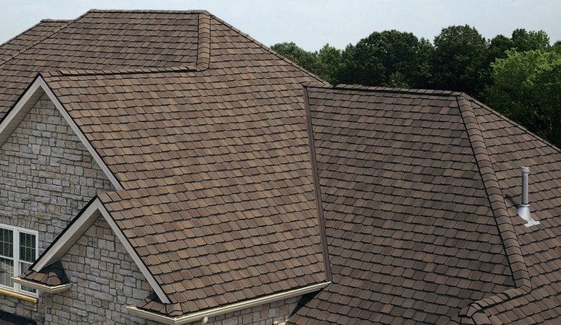 stone house with asphalt shingle roofing