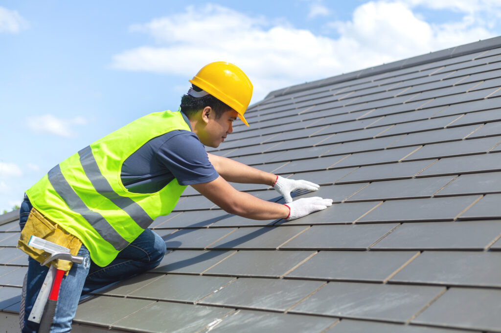 Builder Working On Commercial Roof Of New