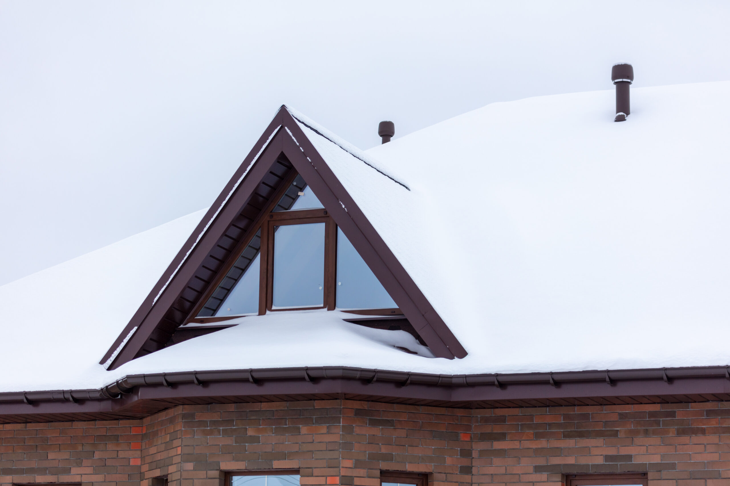 White snow on the roof of the house.
